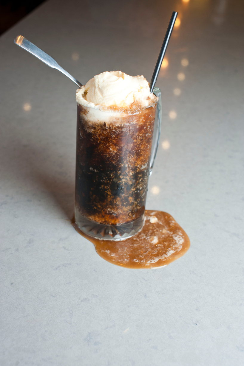 Root beer float. Alcoholic Drinks made with gin, vodka, rum or whiskey mixed with soda water, fruit juices and garnishes with limes and cherries. Classic American bar drinks.