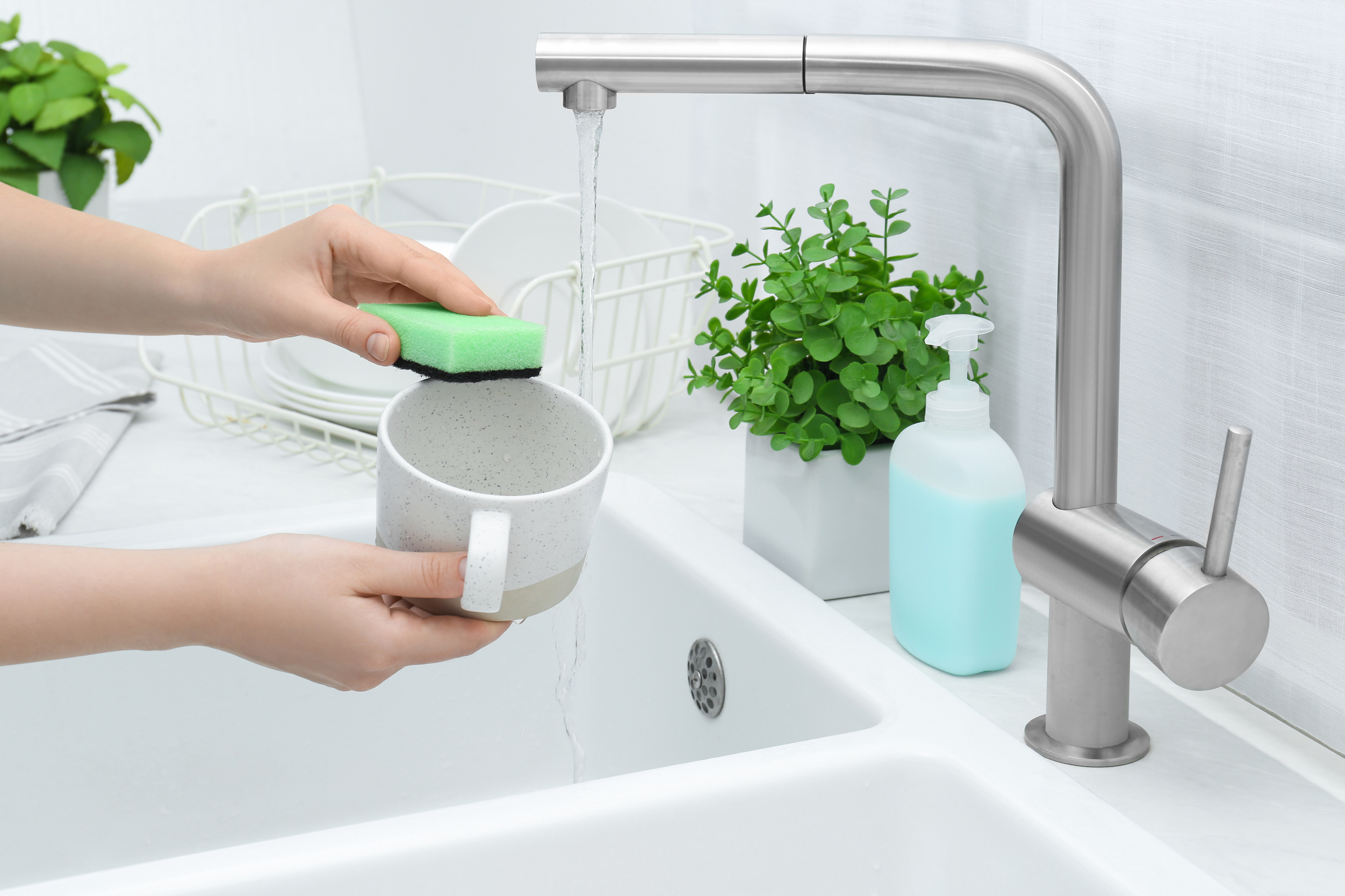 Woman Washing Cup in Kitchen Sink, Closeup